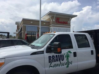 Bravo Landscape truck in front of Chick-fil-A, a commercial landscape customer.