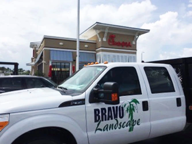 Bravo Landscape truck in front of commercial service customer.