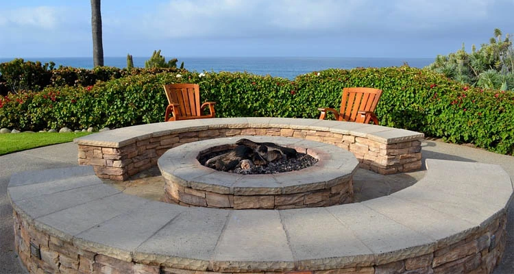 Custom fire pit made from stone with seating.