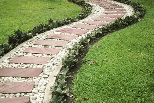 Custom stone path with plants around the edge.